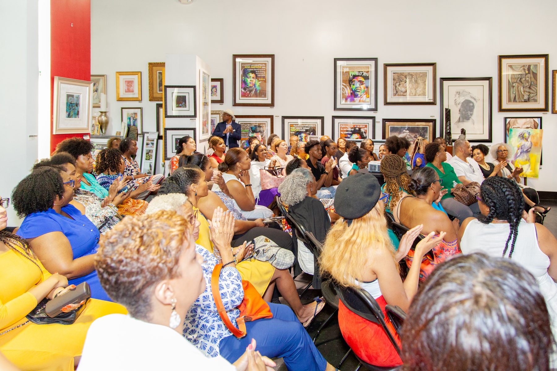Women seated shoulder to shoulder through the program